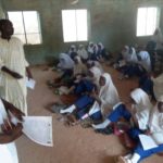 Students sit on bare floor as administrator locks away furniture