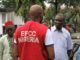 filename 0Prince Benjamin Apugo R with an EFCC agent during his ar