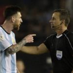 Lionel Messi argues with a referee