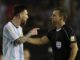 Lionel Messi argues with a referee