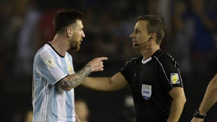 Lionel Messi argues with a referee