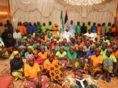 Buhari in the middle sitting back row with Chibok Girls