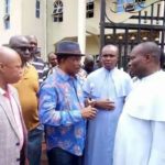 Gov. Willie Obiano in cap speaking with the priests of St Philip Catholic Church Ozubulu