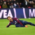 Neymar writhing in pain holds the injured ankle