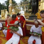 Soccer coach Ekkapol Chantawong right and members of the team who were rescued last week from a flooded cave have their heads shaved in a traditional Buddhist ceremony