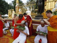 Soccer coach Ekkapol Chantawong right and members of the team who were rescued last week from a flooded cave have their heads shaved in a traditional Buddhist ceremony