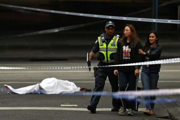 A dead victim of the knife attack in Melbourne Australia and a person being asked to leave the area by police e1541751019698