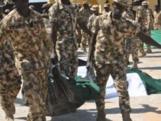 Soldiers taking their collegue for burial yesterday 891x470