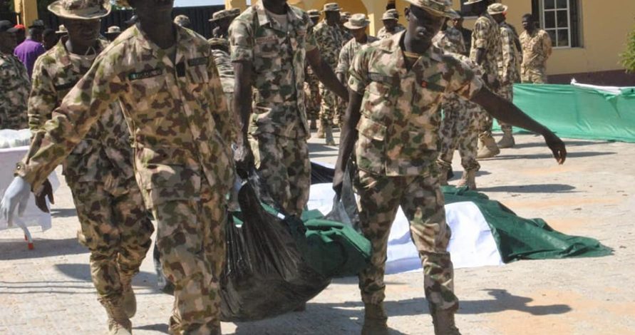 Soldiers taking their collegue for burial yesterday