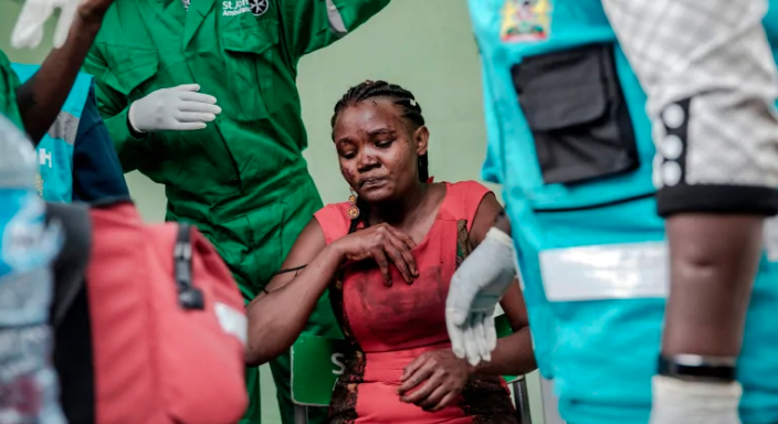 An injured woman receives medical attention at the scene of an explosion at a hotel complex in a Nairobi suburb. (Luis Tato/AFP/Getty Images)