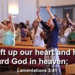 We lift up our heart and hands Toward God in heaven