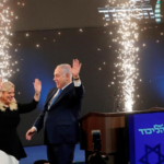 Israeli Prime Minister Benjamin Netanyahu and his wife Sara react as they stand on stage following the announcement of exit polls in Israel's parliamentary election at the party headquarters in Tel Aviv, Israel April 10, 2019. REUTERS/Ronen Zvulun