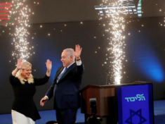 Israeli Prime Minister Benjamin Netanyahu and his wife Sara react as they stand on stage following the announcement of exit polls in Israel's parliamentary election at the party headquarters in Tel Aviv, Israel April 10, 2019. REUTERS/Ronen Zvulun
