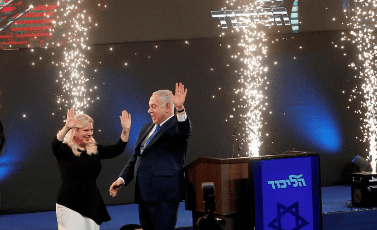 Israeli Prime Minister Benjamin Netanyahu and his wife Sara react as they stand on stage following the announcement of exit polls in Israels parliamentary election at the party headquarters in Tel Aviv Israel April 10 2019 REUTERSRonen Zvulun