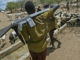 armed turkana herdsmen guard their livestock at a watering hole at picture id57104283 1