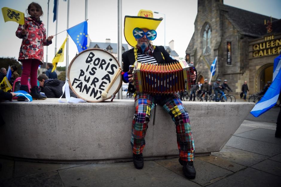 A demonstrator plays the accordion as he waits to attend a pro independence march through the centre of Edinburgh Scotland.