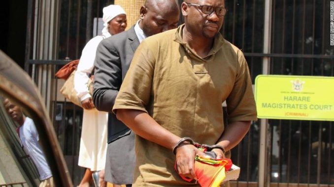 Zimbabwean pastor and activist Evan Mawarire clutches his Bible after being arrested and sent to Harare's Magistrates Court.