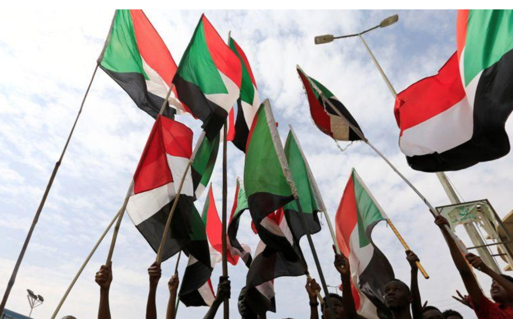 People wave national flags in a file photo during a protest in Khartoum, Sudan August 1, 2019. REUTERS/Mohamed Nureldin Abdallah/File Photo