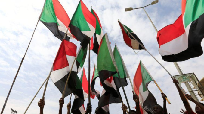 People wave national flags in a file photo during a protest in Khartoum, Sudan August 1, 2019. REUTERS/Mohamed Nureldin Abdallah/File Photo