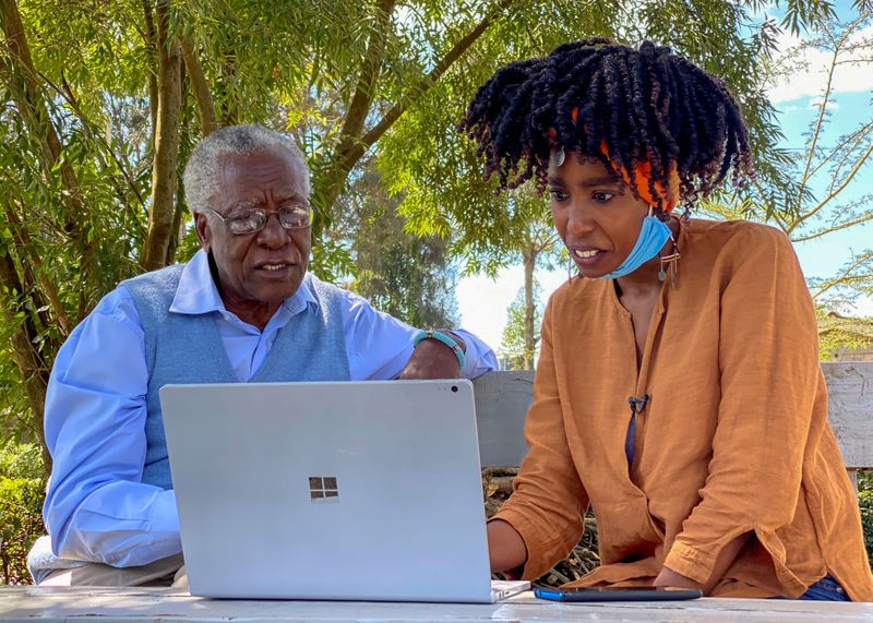 Chao Tayiana, a digital historian, and her grandfather Daniel Sindiyo look at the reconstructed 3D models of the detention camps, during a Reuters interview in Ngong