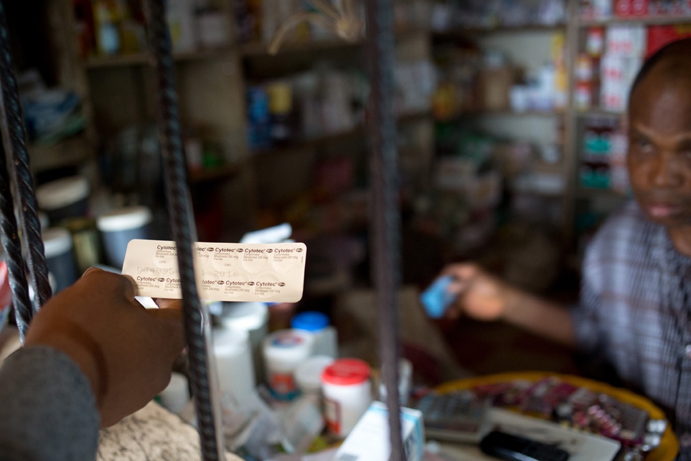 LAGOS, NIGERIA - AUGUST 31:  A  vendor sells a patient ten 200mcg pills of the prescription drug Cytotec-- enough to induce an abortion-- over the counter at a pharmacy in the Kirikiri neighborhood of Lagos, Nigeria, August 31, 2013.  Cytotec, a trade name for the drug misoprostal, is used at lower doses to induce labor and slow post-partum bleeding, but has been widely used for self-induced abortions in Nigeria. The ten pills cost 1,100 Naira, about $7US. (photo by Allison Shelley)