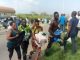 Nigerians carrying food items collected from Covid-19 Palliatives Warehouse