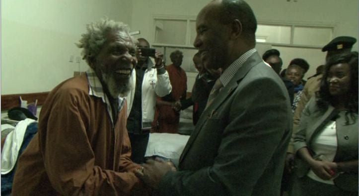 A Mau Mau war hero embraces Nyandarua Governor Francis Kimemia of Kenya on Tuesday, November 13, 2017