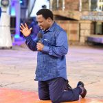 Prophet TB Joshua kneeling down