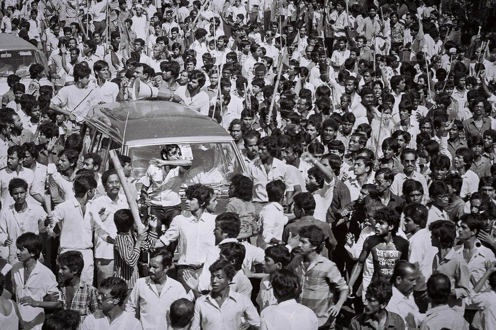 image captionNoor Hossain in the crowd. bottom right, moments before he died.