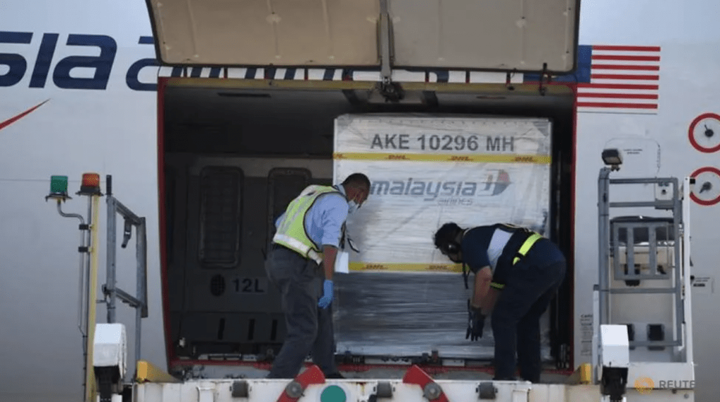 Containers carrying the first batch of Pfizer-BioNTech COVID-19 vaccines are unloaded from a plane at the MASkargo Complex in Sepang, Malaysia on Feb 21, 2021. (Photo: Reuters/Malaysia Information Department/Fandy Azlan)