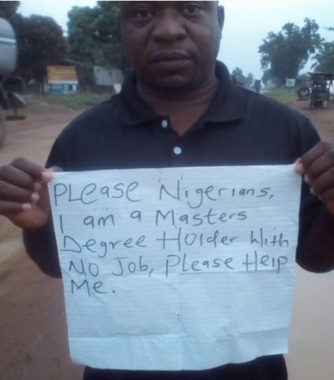 Man displaying placard saying, I'm a Master Degree Holder, No Job