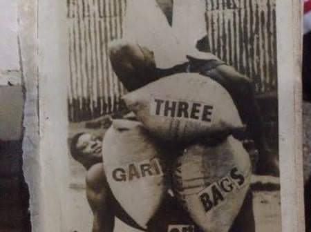 Nwaozize “Killiwe” Nwachukwu - power display where 3 100 KG bags of grains were loaded on his stomach with a man sitting on the top