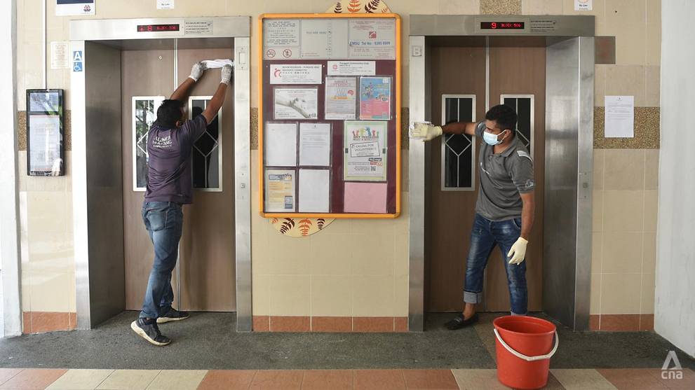 Aljunied-Hougang Town Council workers clean the lift lobby area of Block 506 Hougang Avenue 8 on May 21, 2021. (Photo- Jeremy Long)