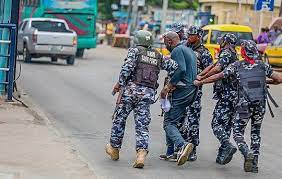 Nigerian Police officers arrest a Yoruba Nation protester