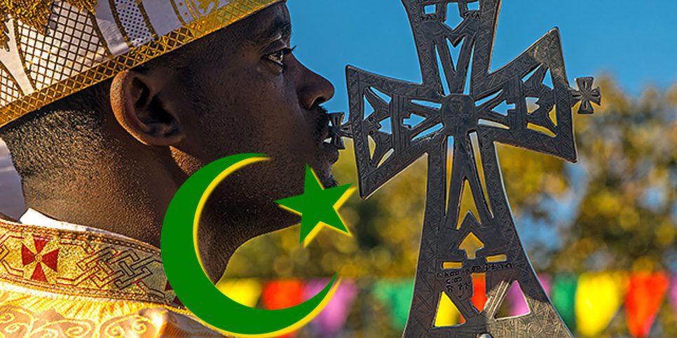 Ethiopian orthodox priest with a cross celebrating the colorful Timkat epiphany festival, Amhara region, Lalibela, Ethiopia