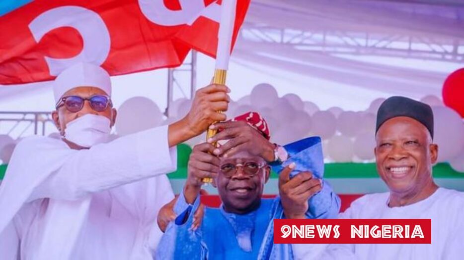 Tinubu holds APC flag after winning APC Presidential Primaries