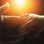 Hand of a man and a childs hand holding unto him