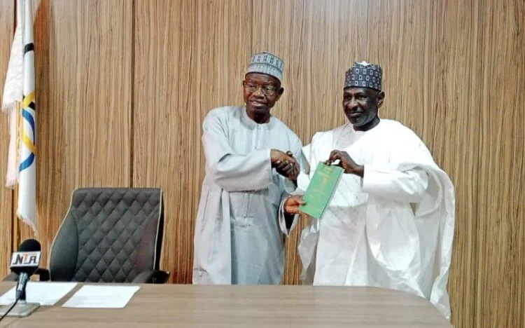 NOC President Habu Gumel with the Chairman of the Constitution Review Committee Hussaini Garun Gabbas receiving the NOC constitution e1707509973756.jpg