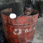 Nigerian Child, Doyin Ajala plays inside a Total oil drum at the waterfront in Lagos, Nigeria Friday, Oct. 17, 2008 Photo by AP Photo/Sunday Alamba /Source — Signal NG/ Ventura