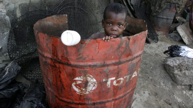 Nigerian Child, Doyin Ajala plays inside a Total oil drum at the waterfront in Lagos, Nigeria Friday, Oct. 17, 2008 Photo by AP Photo/Sunday Alamba /Source — Signal NG/ Ventura