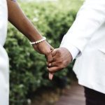 Married couple holding hands
