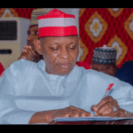 Governor Abba Yusuf signing a doument 1