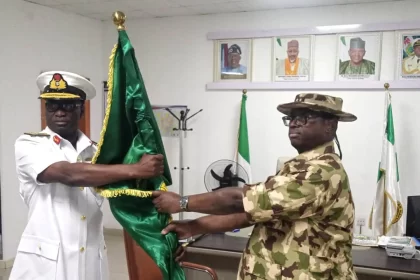 L R Outgoing Flag Officer Commanding FOC the Naval Training Command Rear Adm Robert Obeya handing over the reins of leadership to his successor Rear Adm Ebiobowei Zipele